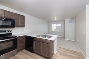 Sioux Falls apartment for rent - A kitchen with a stove, microwave, and sink.