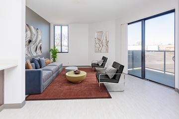 Des Moines apartment for rent - A living room with a grey couch, a yellow coffee table, and a painting on the wall.