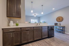 Johnston apartment for rent - a large kitchen with wooden cabinets and a clock on the wall