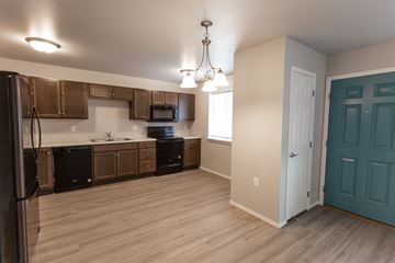 Sioux Falls townhouse for rent - an empty kitchen with wood flooring and a blue door