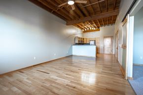 Sioux Falls apartment for rent - an empty living room with wood floors and a kitchen