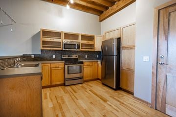 Sioux Falls apartment for rent - a kitchen with stainless steel appliances and wooden cabinets