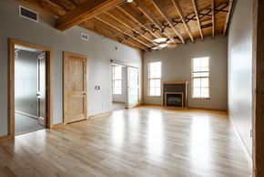 Sioux Falls apartment for rent - an empty living room with wooden floors and a fireplace
