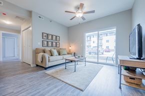 Johnston apartment for rent - a living room with a couch and a ceiling fan and a tv