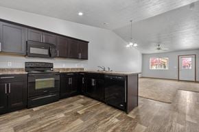 Brandon townhouse for rent - A kitchen with dark wood cabinets and appliances.