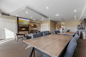 Sioux Falls apartment for rent - A modern dining room with a large wooden table and grey chairs.