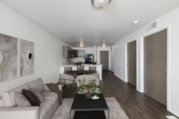 Sioux Falls apartment for rent - A modern living room with a white couch and a coffee table.
