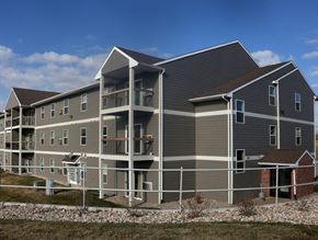 Sioux Falls apartment for rent - a building with gray siding and a fence