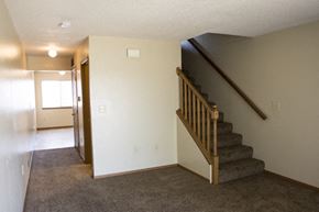 Sioux Falls apartment for rent - a living room with a staircase and a white wall