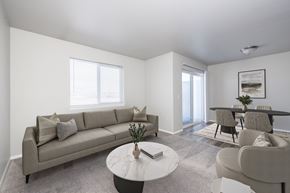 Sioux Falls apartment for rent - A living room with a grey couch, a white coffee table, and a grey chair.
