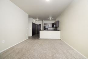 Sioux Falls apartment for rent - A spacious room with a kitchen area in the background.