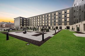Sioux Falls apartment for rent - A modern building with a courtyard in front.