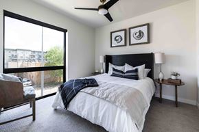 Sioux Falls apartment for rent - A bedroom with a large bed and a ceiling fan.