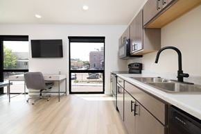 Sioux Falls apartment for rent - A modern kitchen with a desk and chair in the foreground.
