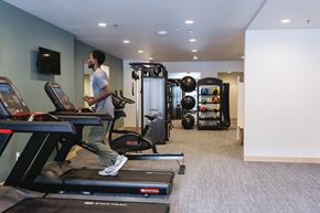 Sioux Falls apartment for rent - A man is running on a treadmill in a gym.