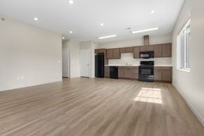 Sioux City apartment for rent - A spacious kitchen with wooden floors and modern appliances.