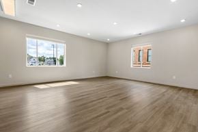 Sioux City apartment for rent - A large empty room with wooden flooring and a window.
