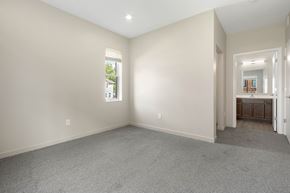 Sioux City apartment for rent - A spacious room with a carpeted floor and a window.