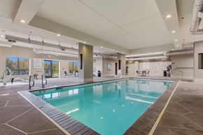 Sioux Falls apartment for rent - A large indoor swimming pool with a tiled floor and walls.