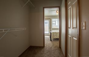 Brandon townhouse for rent - a bedroom with a closet and a bed and a closet door