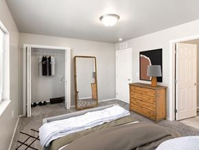 Sioux Falls townhouse for rent - a bedroom with a bed and closet and a mirror