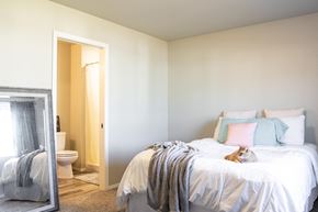 Sergeant Bluff townhouse for rent - a bedroom with a bed and a cat laying on it