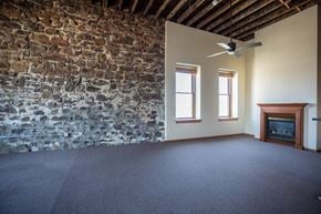 Sioux Falls apartment for rent - an empty living room with an exposed brick wall