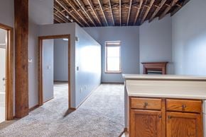 Sioux Falls apartment for rent - an empty room with blue walls and a white counter and a door to a bedroom