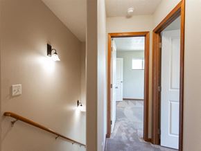 Brandon townhouse for rent - a view of a hallway with a staircase and a door to a bedroom