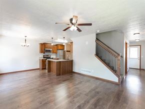Brandon townhouse for rent - an empty living room and kitchen with a ceiling fan