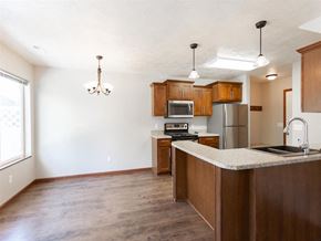 Brandon townhouse for rent - a kitchen with wooden cabinets and a counter top