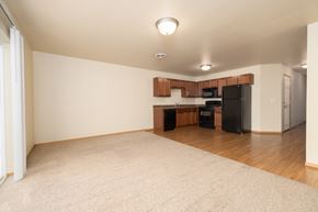 Mitchell townhouse for rent - A kitchen area with a black fridge, microwave, and oven.