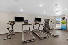 Rapid City apartment for rent - A gym with treadmills, exercise bikes, and a television.