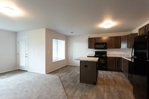 Sioux Falls apartment for rent - an empty kitchen with black appliances and wooden cabinets