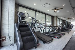Sioux Falls apartment for rent - a gym with cardio equipment and glass windows