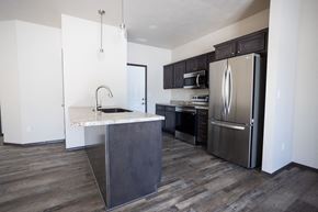 Sioux Falls townhouse for rent - a kitchen with stainless steel appliances and a marble counter top