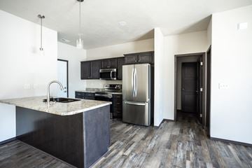 Sioux Falls townhouse for rent - a kitchen with stainless steel appliances and a marble counter top
