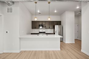 Des Moines apartment for rent - A modern kitchen with a white island and wooden floors.