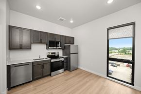Des Moines apartment for rent - A kitchen with dark brown cabinets and stainless steel appliances.