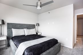 Sioux Falls apartment for rent - a bedroom with a bed and a ceiling fan