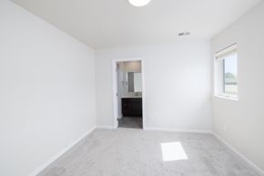 Sioux Falls apartment for rent - A spacious room with a carpeted floor and a small closet with a door.