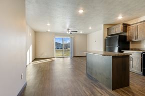 Harrisburg townhouse for rent - A kitchen with a black refrigerator and wooden cabinets.