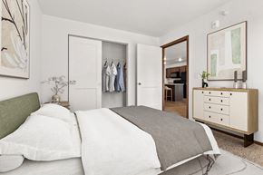 Sioux Falls apartment for rent - A bedroom with a bed, dresser, and mirror.
