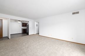 Sioux Falls apartment for rent - A spacious room with a carpeted floor and a ceiling fan.