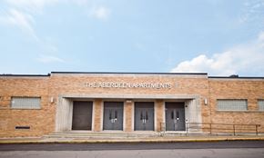 Sioux City apartment for rent - The Aberdeen Apartments is a brick building with three doors.