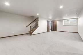 Brandon townhouse for rent - A spacious room with a staircase and a window.