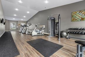 Sioux Falls townhouse for rent - A gym with a variety of equipment including weights and a bench.