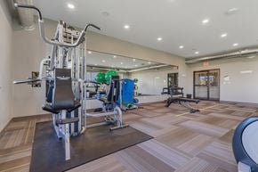 Sioux Falls townhouse for rent - A gym with a variety of equipment including a leg press machine.