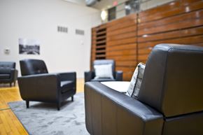 Sioux City apartment for rent - A black leather couch sits in a room with other black leather furniture.