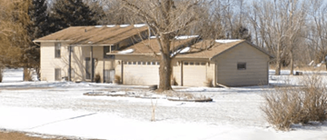 Sioux Falls apartment for rent - a house with a tree in front of it in the snow